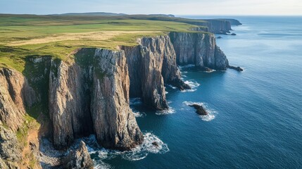 Obraz premium Dramatic Coastal Cliffs and Green Plateau Meeting the Blue Sea Landscape