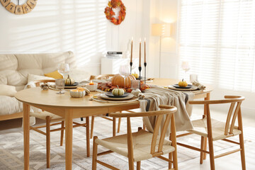 Stylish table setting with beautiful dishware and autumn decor in dining room