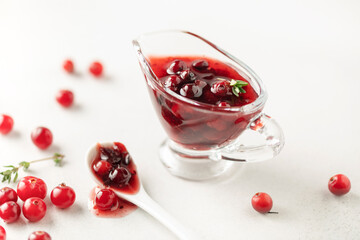 Homemade cranberry sauce in glass bowl. Fresh berry and thyme