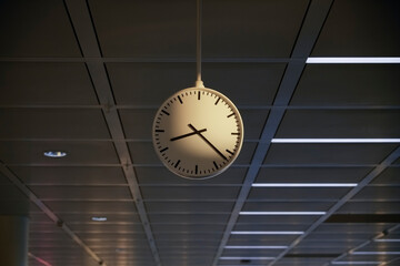 The airport clock photo represents the anticipation and transience of travel. Its minimalist design emphasizes the importance of every minute before the flight, horizontal shot