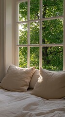 Fototapeta premium Sunlight streams through sheer curtains, revealing a plush sofa and lush green trees in the peaceful outdoor view