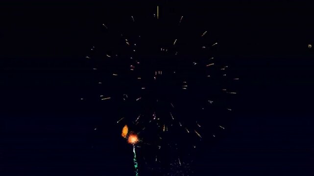 Retro pixel art-style animation of multi-colored fireworks bursting against a dark sky. Vibrant 8-bit explosions create a nostalgic, arcade-era feel with smooth looping motion