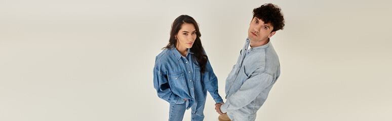 Young fashion enthusiasts showcase trendy denim styles in a vibrant indoor setting