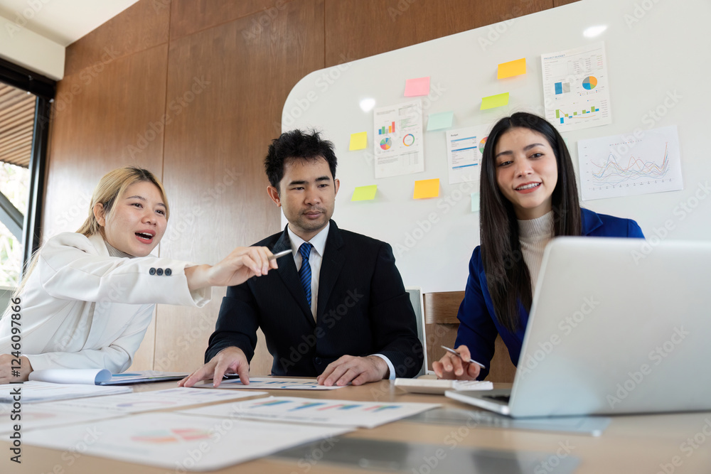 Poster diverse business team collaborating on financial analysis and strategy in a modern office setting.