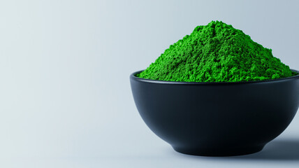 Green powder in black bowl, isolated on light background, showcasing its vibrant color and fine texture. Perfect for culinary or health related uses