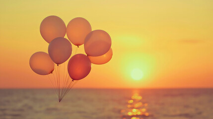 Fototapeta premium Floating Balloons at Sunset Over the Ocean Celebrating Summer Joy