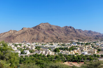 Scenic aerial view of Hatta, UAE, traditional architecture, lush greenery, and rugged mountains. A perfect travel destination for nature lovers and cultural explorers