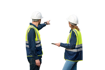 Engineers wearing safety gear, including hard hats examining survey standing industrial facility...