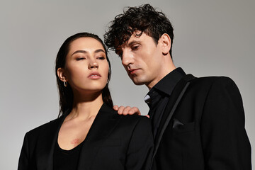 Stylish young couple showcasing modern fashion in a minimalistic setting