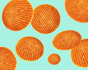 Stroopwafels flying in the air. Set of many waffles levitating at different angles, isolated on turquoise background Traditional Dutch caramel cookie. Creative food concept