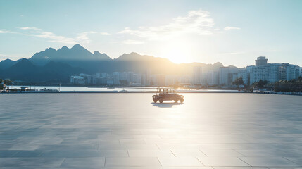 Serene sunrise over a coastal city with a small vehicle in the foreground, offering a tranquil and peaceful urban landscape scene.