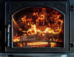 Fire with wood in the stove close up