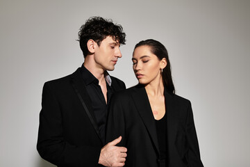 Stylish couple embraces a modern elegance in a minimalist fashion setting