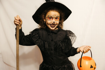 Portrait of a smiling girl dressed as a witch looking at the camera, copy space.