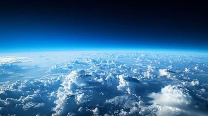 Naklejka premium Experience the breathtaking beauty of a cloud-covered expanse stretching endlessly across the horizon. This stunning view captures the serene interplay of light and clouds in the atmosphere