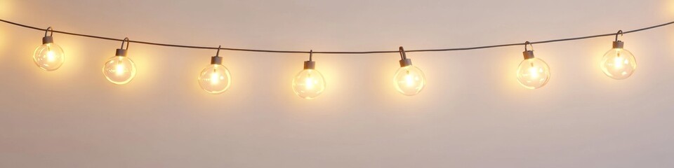 Warm-toned bulb string lights on wall, simple background, home decor