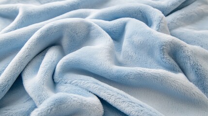 Fototapeta premium A plush, powder blue blanket lies gracefully folded on a soft surface, inviting moments of coziness and relaxation. Its gentle texture complements a calming atmosphere, perfect for unwinding