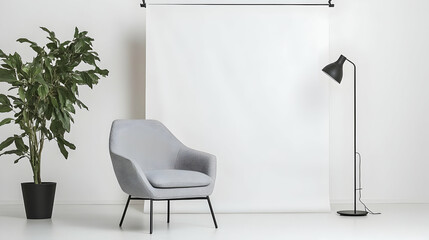 Modern gray armchair in a minimalist white room with plant. Possible use Interior design inspiration, furniture catalog