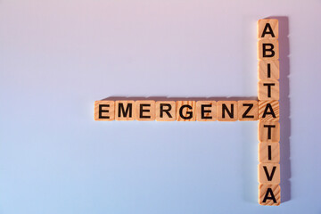 words with wooden letters, housing emergency, on colored background