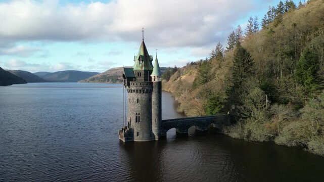 Lake Vyrnwy Straining Tower drone clockwise rotate and move in close on a crisp, calm, sunny winter afternoon - Wales, UK