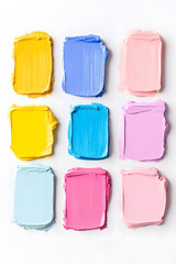 Pastel oil paint swatches with pale pink, blue, blue marine colors isolated on white backdrop