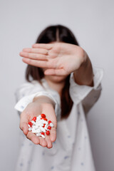 Female holding many pills in hand and covering his face with his hand. Women with tablets in hand....