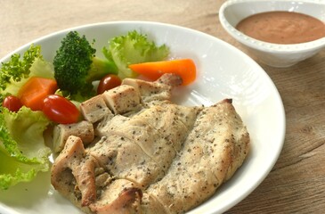 grilled slice chicken breast steak black pepper with barbecue sauce and baking vegetable salad on plate 