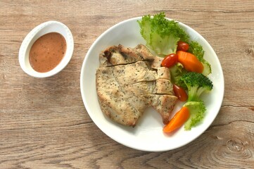 grilled slice chicken breast steak black pepper with barbecue sauce and baking vegetable salad on plate 