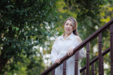 portrait of asian woman wearing white dress in the park, my vacation relax