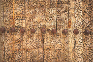 Closeup view of old wooden carved door at Ichan Kala heritage town