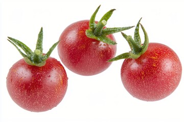 Obraz premium Three fresh red cherry tomatoes with green stems on a clean white background close up view