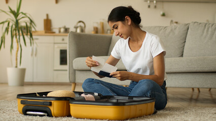 Indian woman Arabian female ethnic girl Hindi lady at home indoors preparing for trip prepare for...