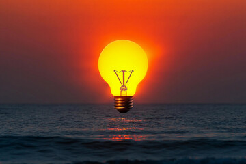 Bright bulb shaped like the sun rising over calm ocean waters at dusk