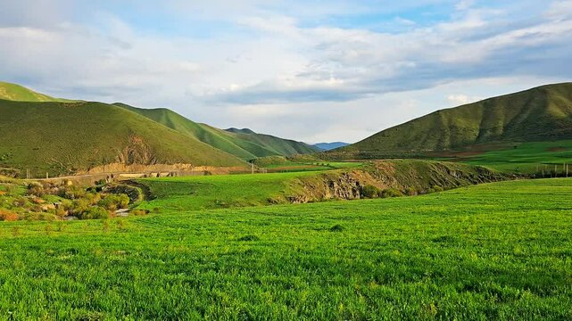 Vast green fields with rolling hills under a partly cloudy sky.
📍Marivan, Kurdistan 