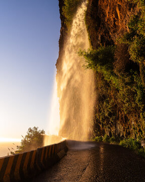 Sunset reflecting in the waterfall Cascata dos Anjos in Madeira, Portugal