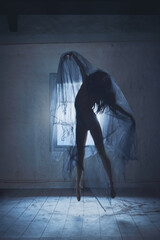 Loneliness, anger, supernatural pressure. Silhouette of woman with dark hair covered in transparent...