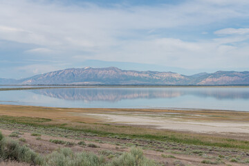 Snow topped mountains reflected in The Great Salt Lake from Antelope Island, Salt Lake City, Utah, USA