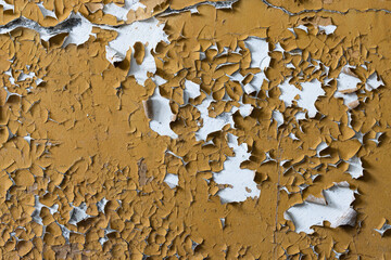 Peeling paint on the wall. Old concrete wall with cracked flaking paint. Weathered rough painted surface with patterns of cracks and peeling. High resolution texture for background and design. Closeup