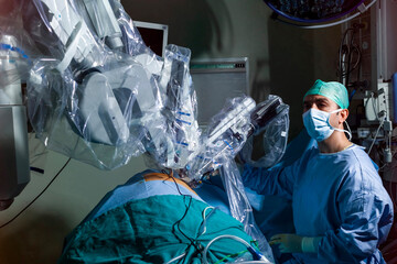 surgeon performing robotic surgery with robotic device. Medical operation involving robot....