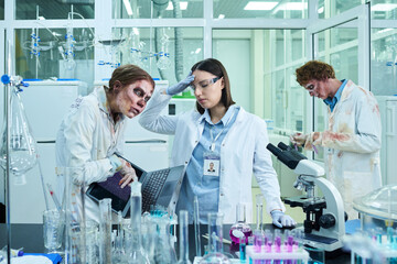 Frustrated Female Scientist Working with Zombie Colleagues in Lab