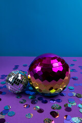 Vibrant disco balls and colorful confetti create a festive atmosphere suitable for celebrations and parties