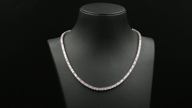 A stunning double-layered diamond necklace displayed on a sleek black jewelry bust, exuding elegance and sophistication. This high-quality 4K close-up video captures the intricate details.