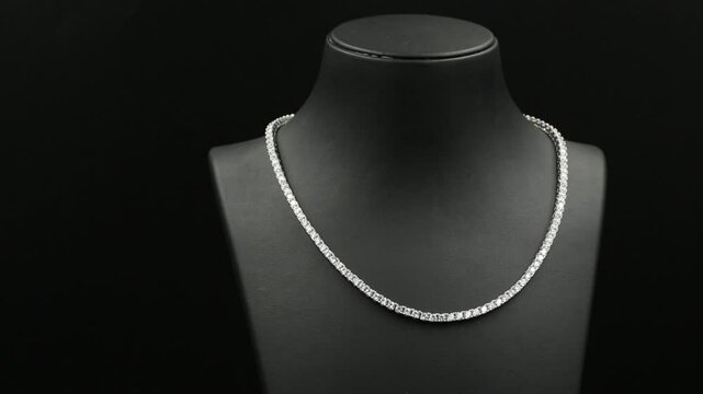 A stunning double-layered diamond necklace displayed on a sleek black jewelry bust, exuding elegance and sophistication. This high-quality 4K close-up video captures the intricate details.