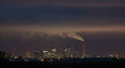 Industrial Smokestacks at Stormy Twilight