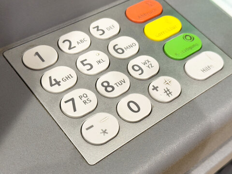 Close-up of atm numeric keypad with colorful function buttons