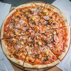 Delicious pizza topped with olives, mushrooms, and ham slices