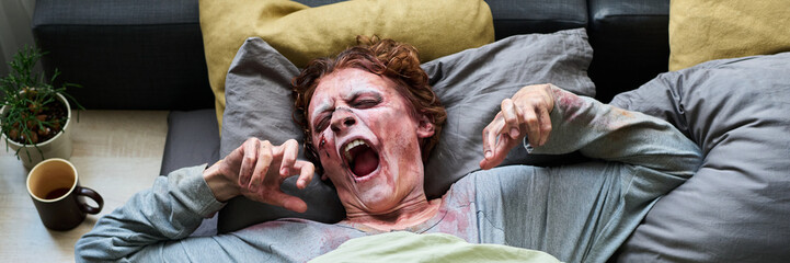 Red-haired Male Zombie Yawning In Bed Header