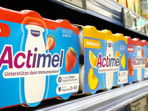 Assorted actimel yogurt bottles on store shelf showcasing flavors and nutritional benefits