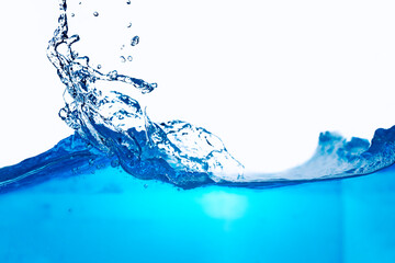 Closeup view of dynamic flowing blue water waves on white background. Liquid splash. Texture and...