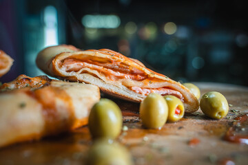 Mouthwatering cal zone cross-section with melted cheese oozing